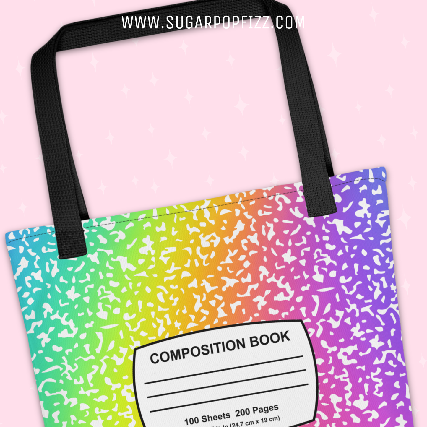 Tote bag with rainbow pattern and 'Composition Book' label on a pink background