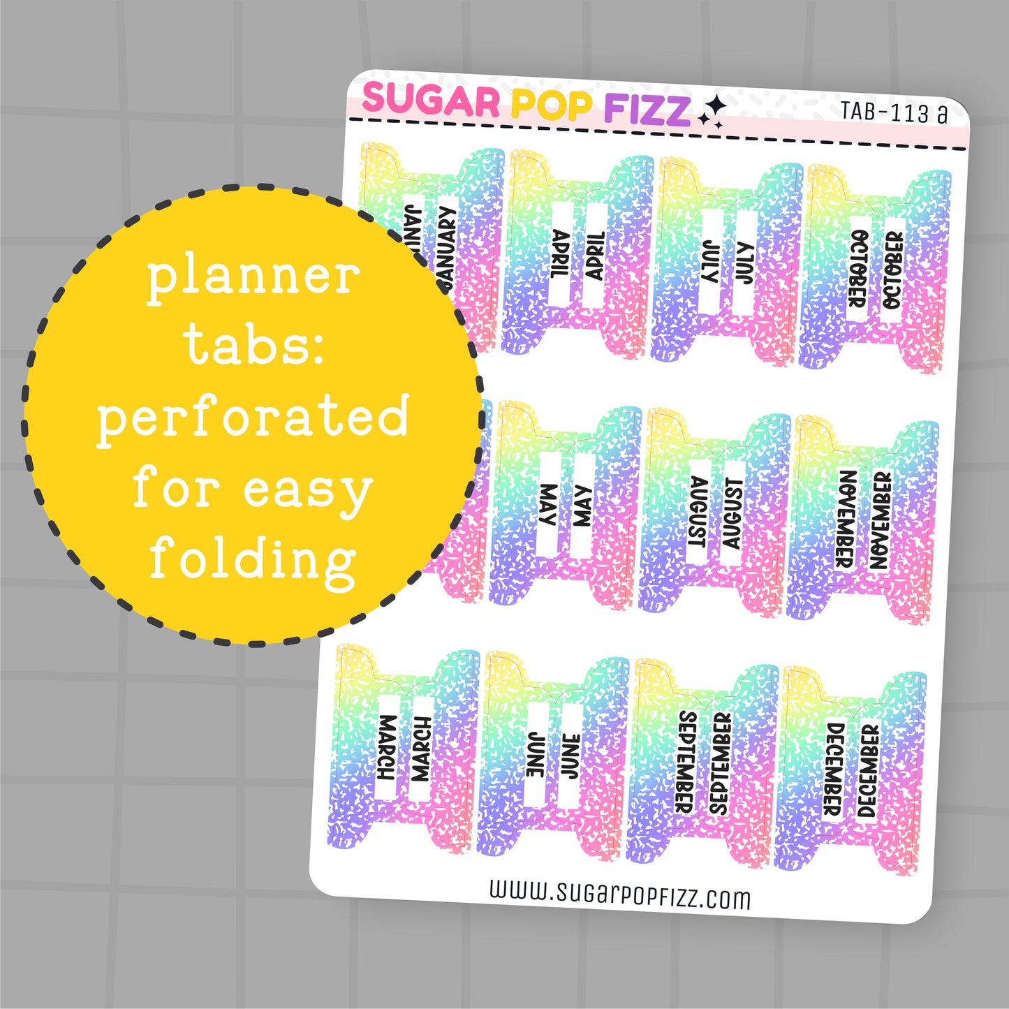 Colorful planner tabs with months printed on them, perforated for easy folding, on a gray grid background.