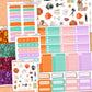 Collection of colorful planner stickers on a wooden surface