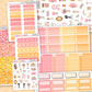 Collection of planner stickers with various designs and colors on a wooden surface.