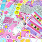 Collection of colorful stickers with various designs on a pink background