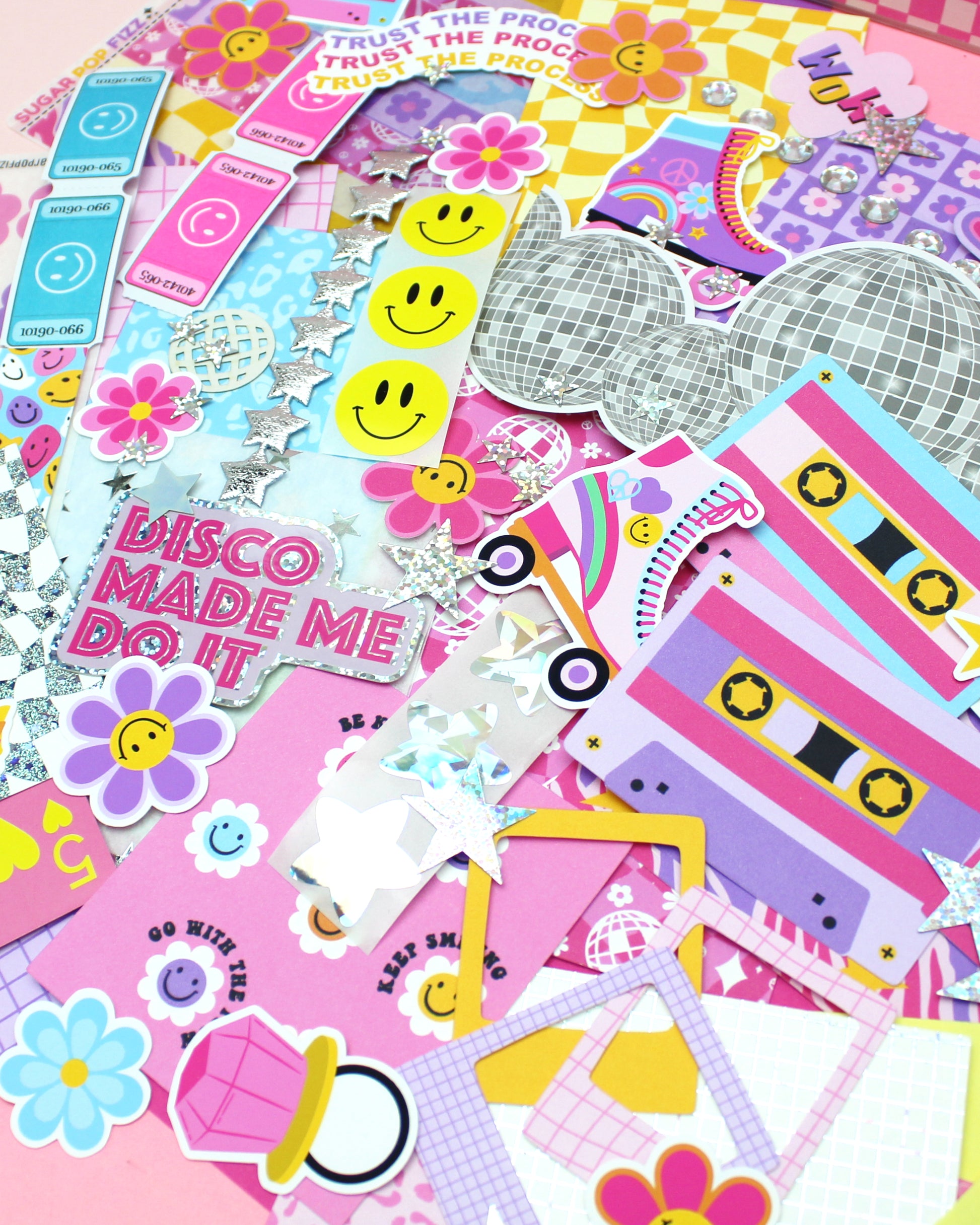 Collection of colorful stickers with various designs on a pink background
