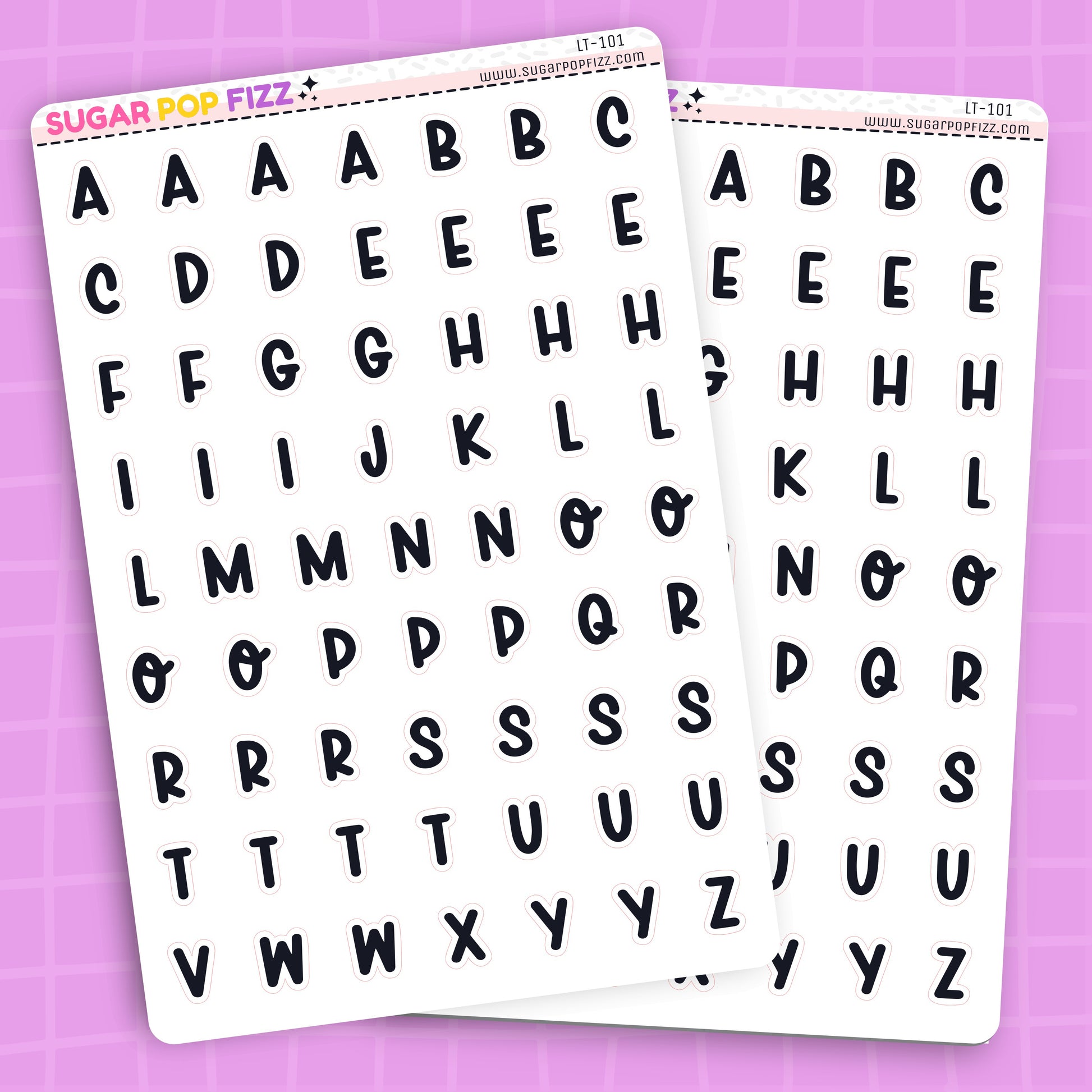 Two sheets of alphabet letter stickers on a pink background