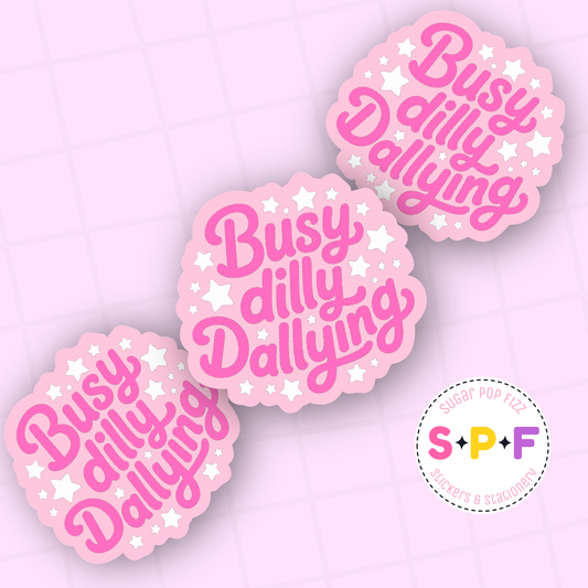 Pink stickers with 'Busy dilly Dallying' text on a light purple background, featuring the brand 'S & PF'.