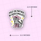 Sticker of a cat in cowboy boots with text 'Hold on partner, I'm overstimulated' on a pink background.