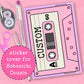 Pink cassette tape-shaped sticker cover for Hobonichi Cousin on a pink background with stationery items.