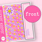 Sticker Keeper planner with pink and purple design and flower sticker on a pink background