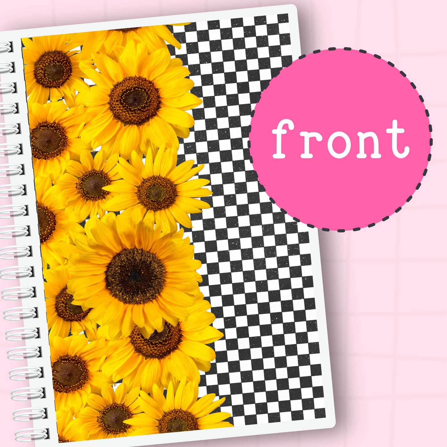 Notebook with sunflower design on one side and checkered pattern on the other, on a pink background.