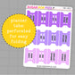 Purple planner tabs with months printed on them, perforated for easy folding, on a gray grid background.